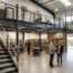 Staff talking in front of mezzanine floor for storage space